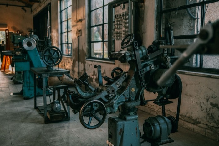 Interior of an older machine shop with belt-driven machine tools